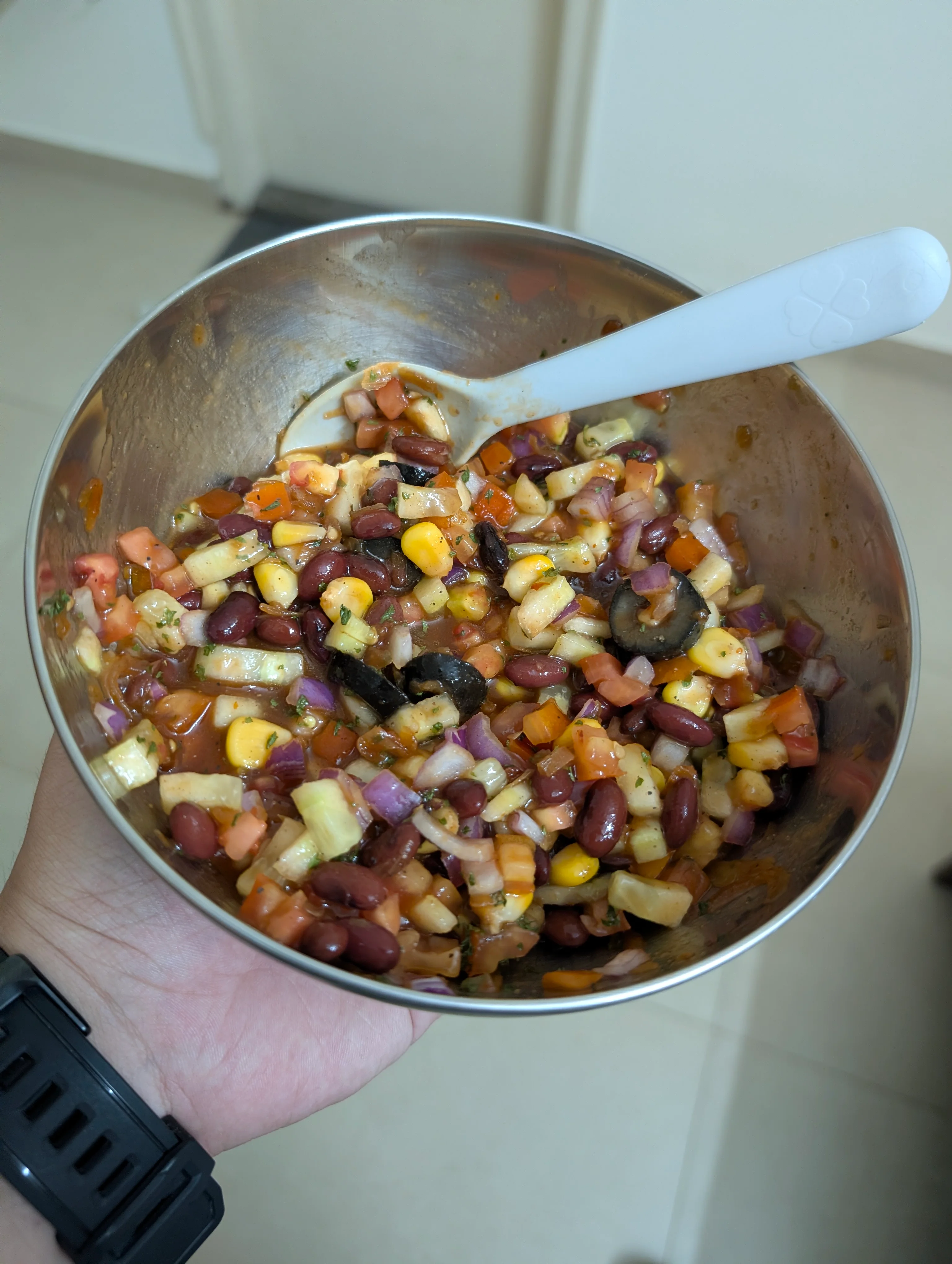 A bean nacho dip with red beans, cucumbers, onions, tomatoes, and corn; all wrapped up in a dressing made with a some jarred salsa, olive oil, apple cider vinegar, onion powder, and a bit of hot sauce.